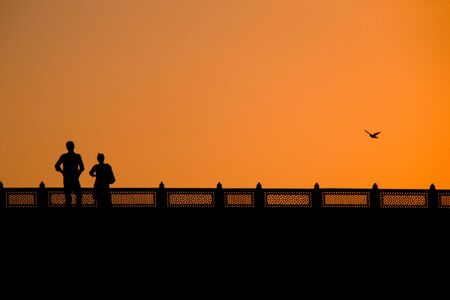 A couple and the sunset in New Delhiの写真素材