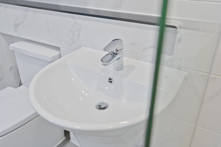 View of the bathroom sink from inside the showerの写真素材