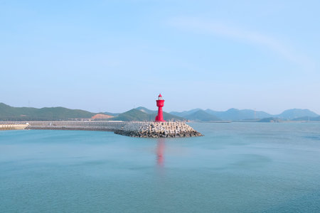 You can see the red lighthouse opposite the nice pier.の写真素材