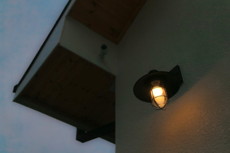 Lantern hanging on the wall of a house in the evening