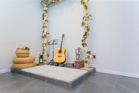 Small musical stage with Spanish guitar and floral decorationsの写真素材