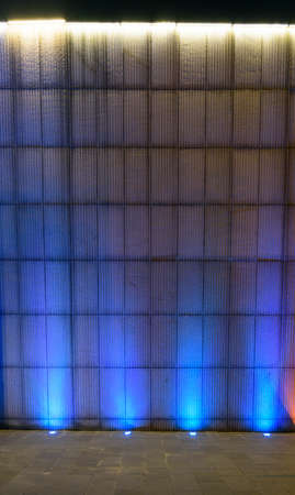 Cement background wall with purple neon lampの写真素材