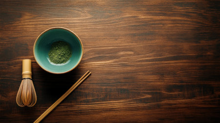 A simple, clean composition of matcha powder, whisk, and bowl on dark wood, leaving space for advertising text.の素材