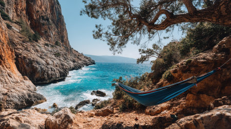 A serene hammock nestled along a rocky coastline invites relaxation. The stunning blue sea and natural surroundings create a perfect getaway for nature lovers.の素材