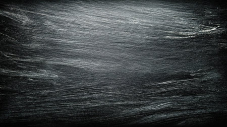 This image features a textured dark surface with subtle striations, perfect for use as a background or in artistic designs, conveying depth and elegance.の素材