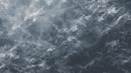 This image captures the dramatic texture of dark ocean waves, showcasing foamy surfaces and mist, perfect for nature-themed projects or backgrounds.の素材