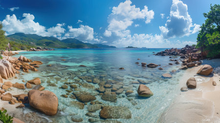 A breathtaking view of a tropical beach with clear blue water, rocky outcrops, and a vibrant sky filled with fluffy clouds. Perfect for summer escapades.の素材