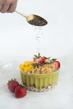Mango Strawberry Banana Smoothie Bowl with Chia Seed in a Takeaway Containerの写真素材