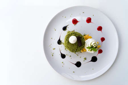 Matcha green tea macadamia cake on a white table. Free space for text . Top viewの写真素材