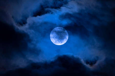 Dark night full moon in the cloudsの写真素材