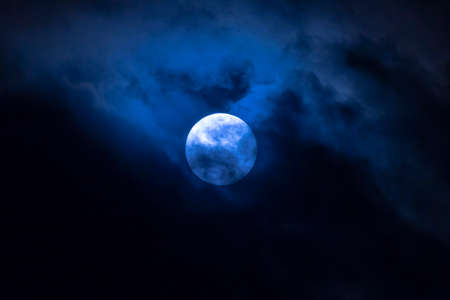Dark night full moon in the cloudsの写真素材