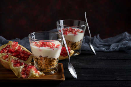 Healthy granola with homemade yogurt parfait and pomegranateの写真素材