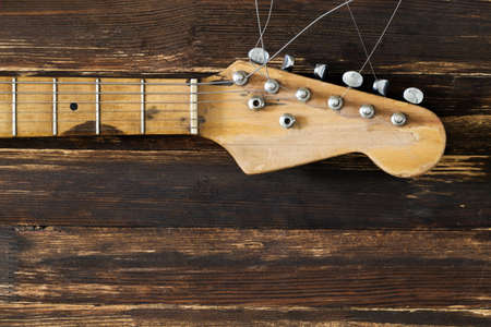 part of the electric guitar on a dark board in backgroundの写真素材