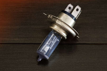 Car halogen lamp on dark wooden texture backgroundの写真素材