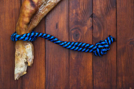 Leg of dried pig meat - ham on a vintage wooden background.の写真素材