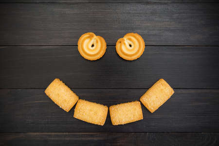 Smiley made up of cookies. Black background.の写真素材