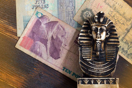 Souvenir sculpture of the Egyptian pharaoh on the money backgroundの写真素材