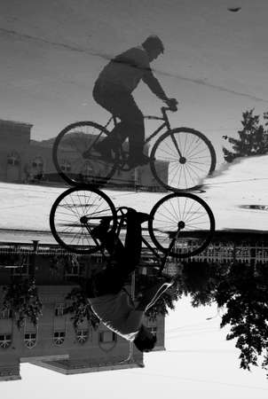 Bmx rider performing tricks in the city. Black and white photo.の写真素材
