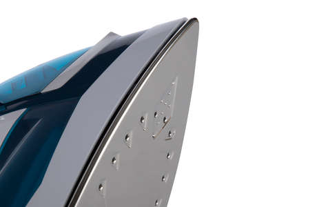 white and blue steam iron on white backgroundの写真素材