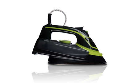 black and green steam iron on white backgroundの写真素材