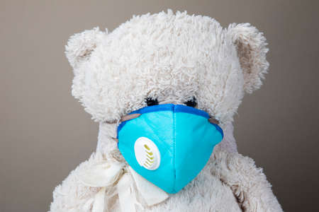 Teddy bear protected by KN95 face mask protection against pm 2.5 contamination and COVID-19 coronavirus. child conceptの写真素材