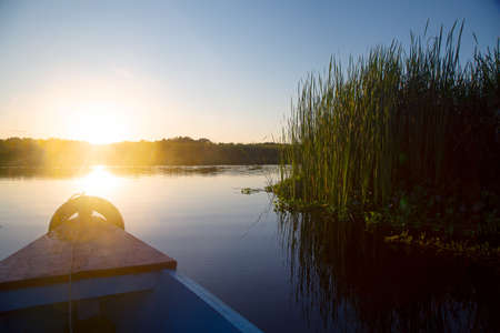 watching the sunrise on a motorboatの写真素材