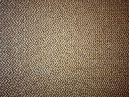 Background or texture of a zigzag woven beige cloth rug, forming a beautiful pattern.