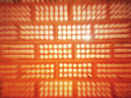 Light entering the holes of a clay brick wall with motion blur. It looks like the light is bouncing off the screen.の写真素材