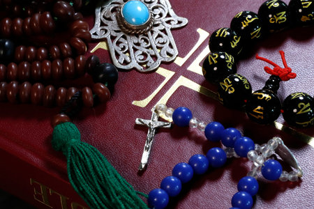 Christianity, buddhism, Islam and Judaism. Interfaith symbols: bible, crucifix, prayer beads and...