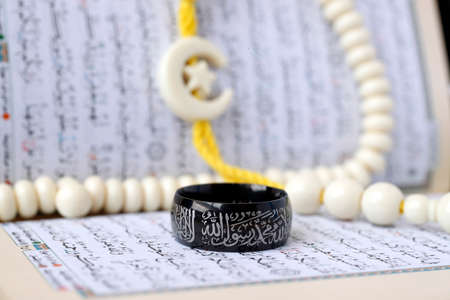 Quran, islamic ring and Tasbih (prayer beads). Muslim symbols. Close-up.の写真素材
