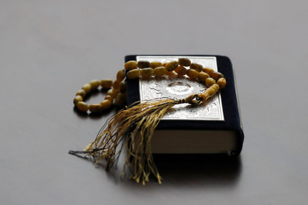 Holy Quran and a muslim prayer beads.