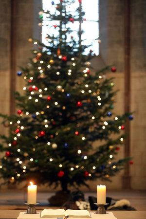 Theodorskirche. Christmaas tree, bible and church candles. Basel. Switzerland.の写真素材