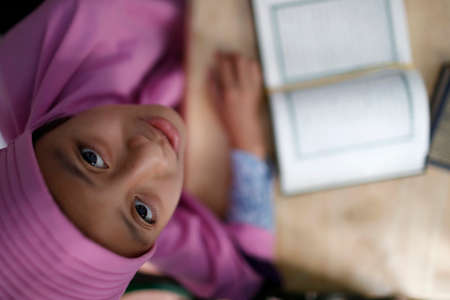 Muslim girl learning Quran at Islamic school.のeditorial素材