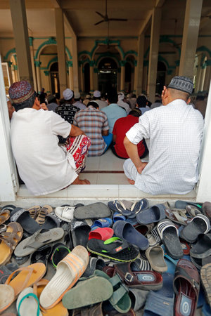 Masjid Nia'mah mosque. Muslim men at the friday prayer (salat). Chau Doc. Vietnam.