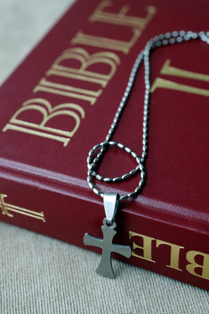 Bible and necklace with cross pendant. Paris. France.