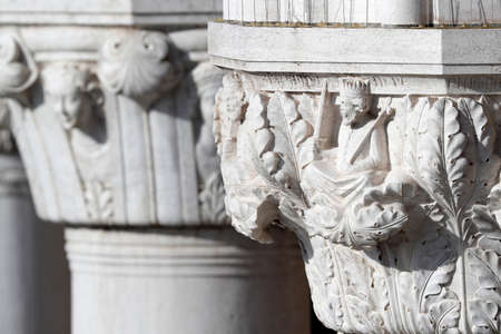 Palazzo Ducale (Doges Palace). White capital sculptures of Doge palace colonnade. Venice. Italy.の写真素材