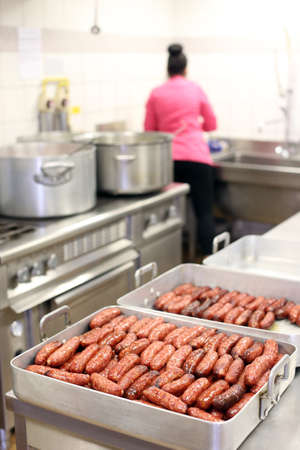 Cooking diots in a kitchen. A diot is a sausage from the French region of Savoy. France.の写真素材