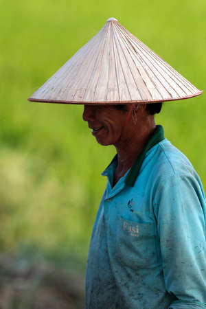 Farmer wearing a tradional palm leaf conical hat. Portrait. Hoi An. Vietnam.の写真素材