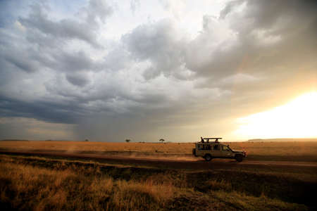 An off-road vehicle driving in the African savanna. Masai Mara game reserve. Kenya.の写真素材