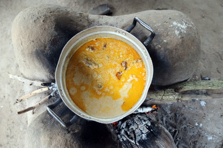 African meal cooking over a fire. Togo.