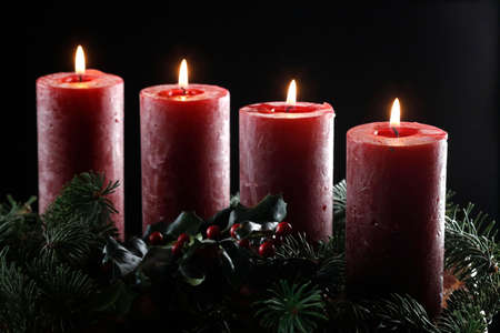 Natural advent wreath or crown with four burning red candles. Christmas composition. France.の写真素材