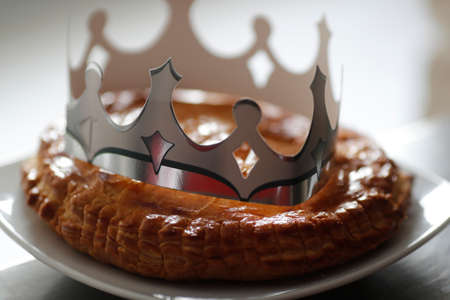 King cake, galette des rois and its crown. A popular food item available beginning January 6, or Epiphany. France.の写真素材