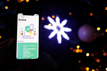 All Anti Covid we have smartphones. French digital application to fight against Covid-19. Christmas tree. France.の写真素材
