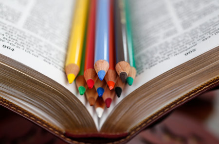 Colored pencils on a bible. Catechism.の写真素材