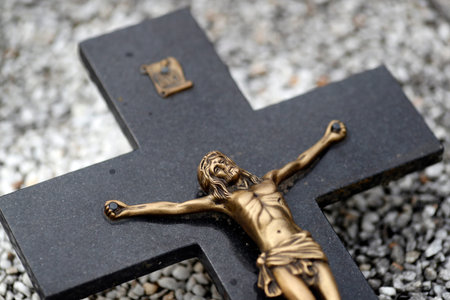 Grave in cemetery. Crucifix. Jesus on the cross.