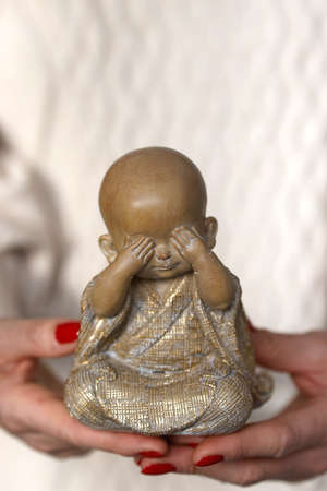 Buddhist monk statue in hand. France.の写真素材