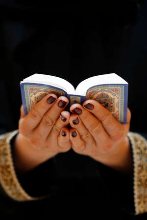 Muslim woman reading the noble Quran. United Arab Emiratesの写真素材