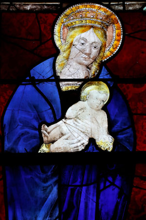 Saint Martin church. Stained glass window. Virgin Mary and infant Jesus. Early 16 th century. Villaz. France.のeditorial素材