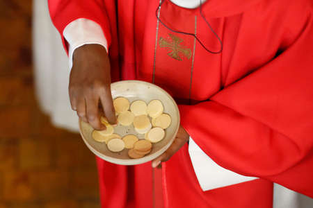 Saint Louis de Novel church. Catholic mass. Priest giving the Holy Communion. Annecy. France.の写真素材