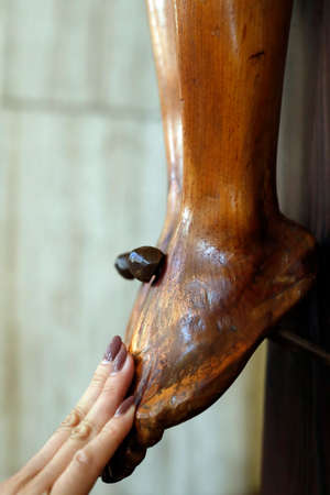 St. James the Apostle church. Jesus Christ statue. The crucifixion. Close-up on feet.の写真素材